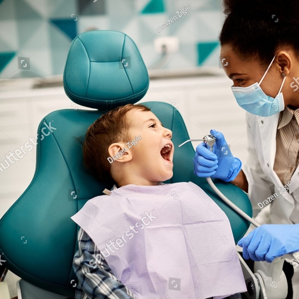 stock-photo-happy-little-boy-having-his-teeth-checked-by-female-dentist-during-appointment-at-dental-clinic-2042666858
